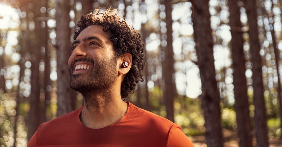 A képen látható sportoló valódi vezeték nélküli fülhallgatót visel 